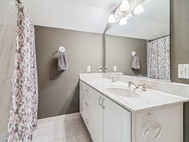 full bathroom featuring a shower with shower curtain, tile patterned flooring, baseboards, and vanity