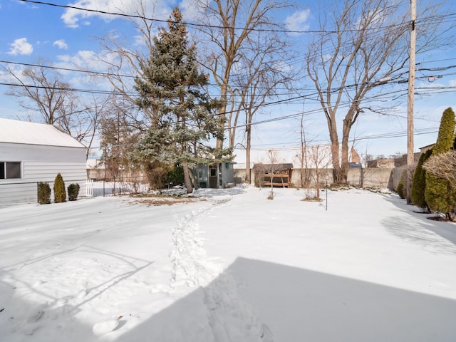 yard layered in snow with fence