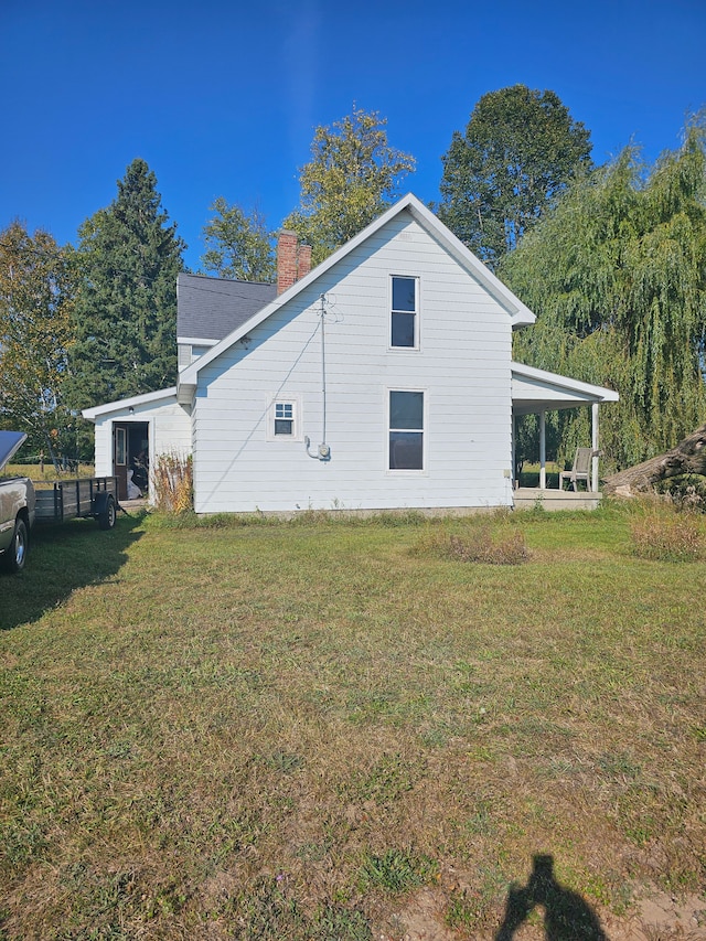 view of side of home with a lawn