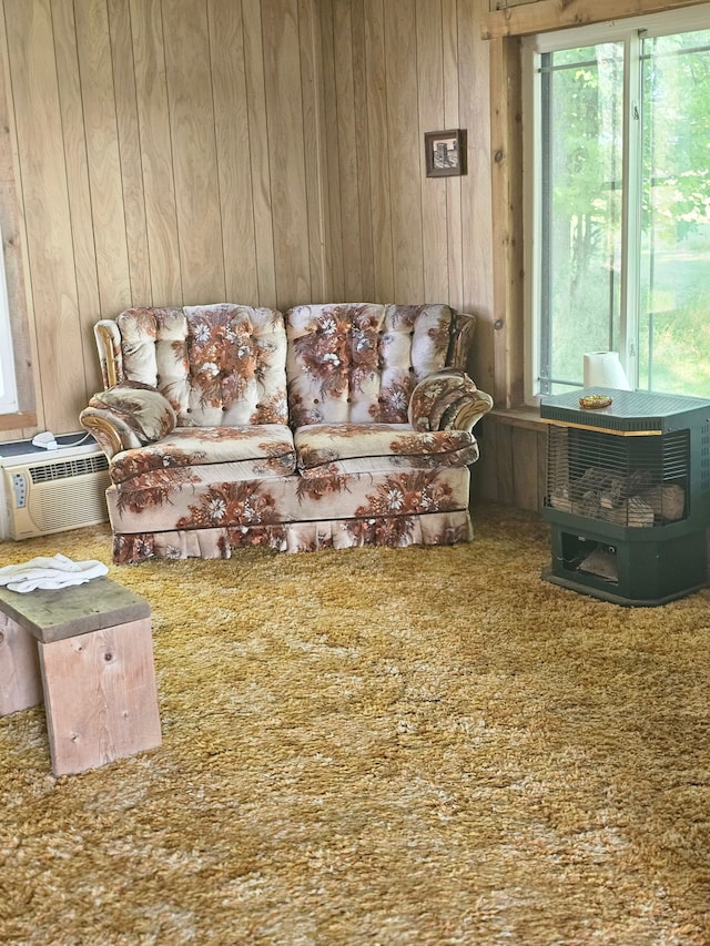 carpeted living room with wood walls and cooling unit