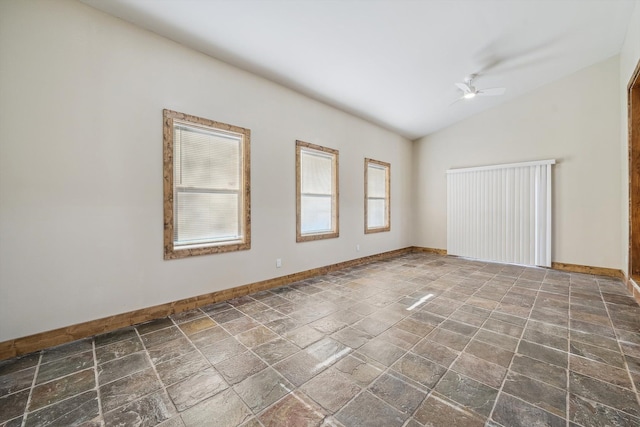 empty room with ceiling fan and lofted ceiling