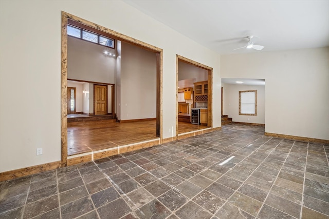 spare room with ceiling fan and beverage cooler