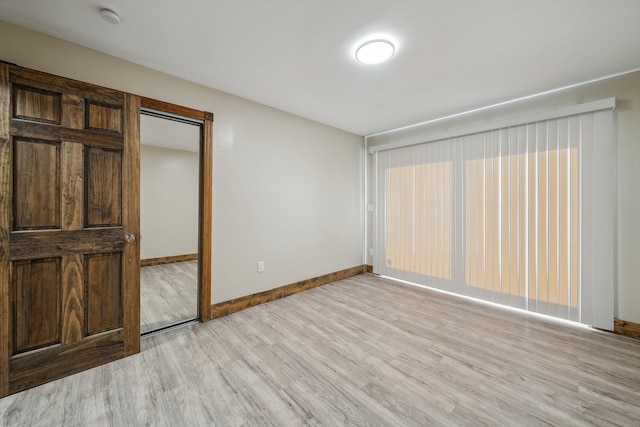 unfurnished bedroom with light hardwood / wood-style flooring and a closet