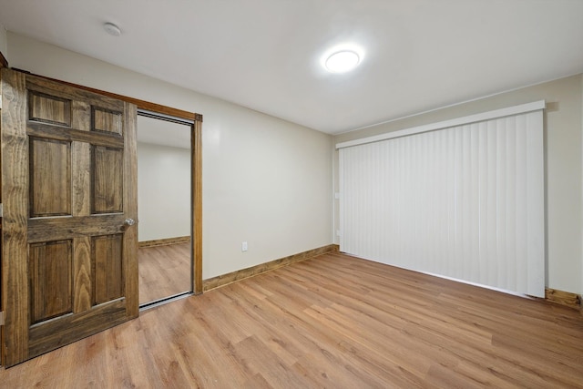 unfurnished bedroom featuring a closet and light hardwood / wood-style floors