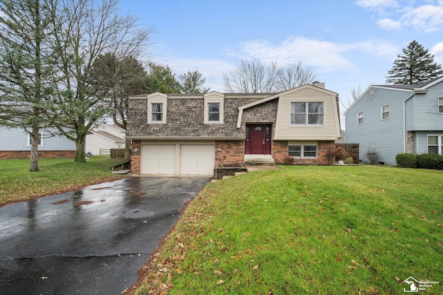 raised ranch featuring a front lawn and a garage