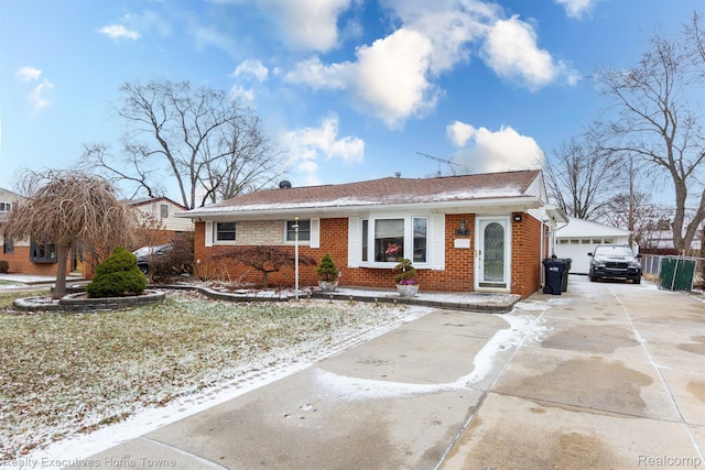 8268 Doncaster Dr, Sterling Heights, MI 48312 - view of front of home with brick siding, a detached garage, roof with shingles, and an outdoor structure