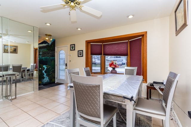 dining area with ceiling fan and light tile patterned flooring