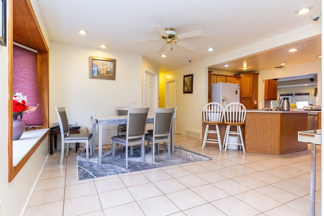 tiled dining space with ceiling fan