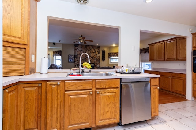 kitchen featuring kitchen peninsula, stainless steel dishwasher, ceiling fan, sink, and light tile patterned floors