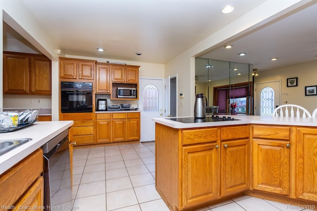 8268 Doncaster Dr, Sterling Heights, MI 48312 - kitchen with black appliances, light countertops, light tile patterned floors, brown cabinetry, and recessed lighting