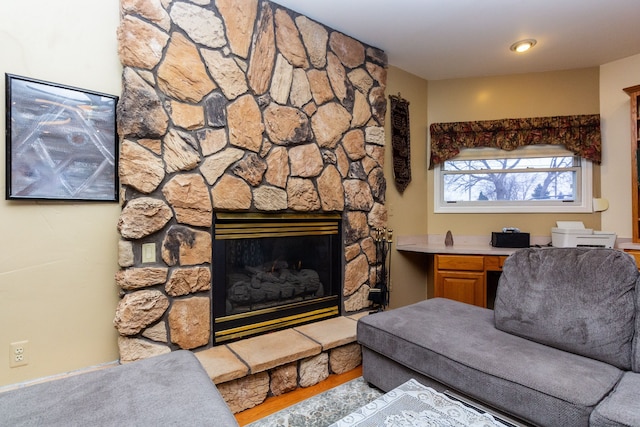 living room with a stone fireplace