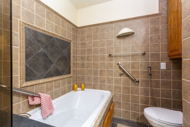 bathroom with a bathing tub, toilet, and tile walls