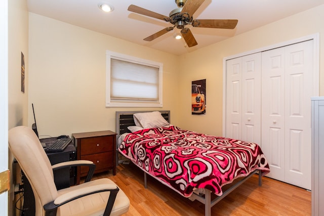 bedroom with ceiling fan, a closet, and light wood-type flooring