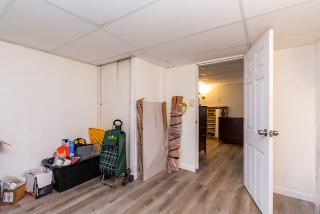 interior space with hardwood / wood-style floors and a drop ceiling