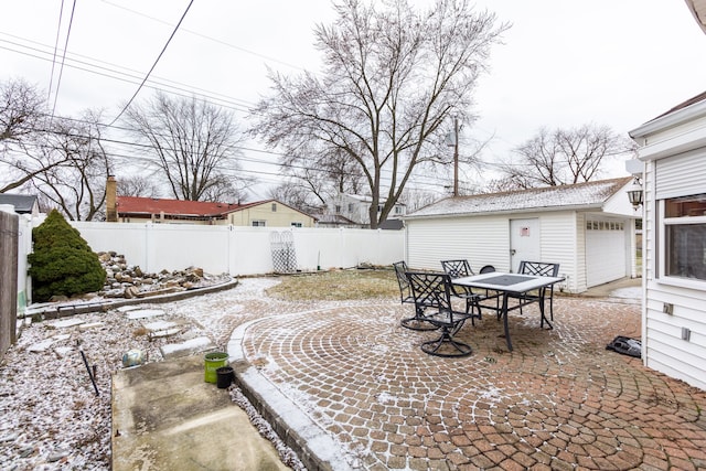 view of yard featuring a garage, an outbuilding, and a patio