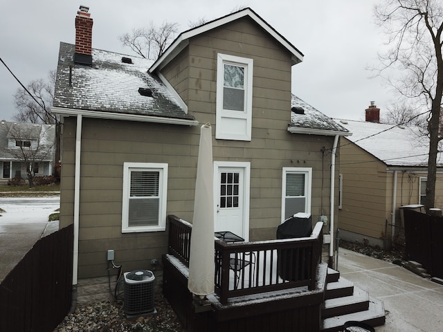 rear view of property with cooling unit