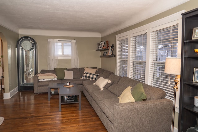 living room featuring a textured ceiling and dark hardwood / wood-style floors