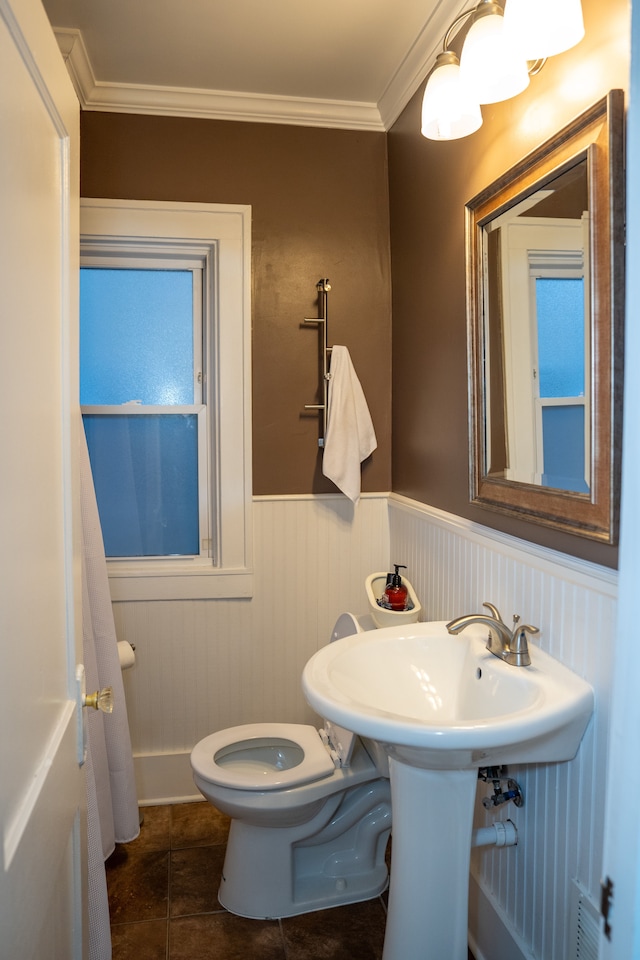 bathroom featuring tile patterned flooring, toilet, and ornamental molding