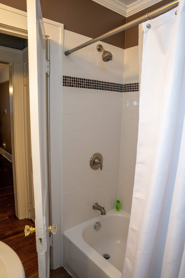 bathroom featuring shower / tub combo with curtain and ornamental molding