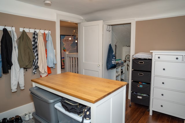 walk in closet featuring dark hardwood / wood-style floors and an inviting chandelier