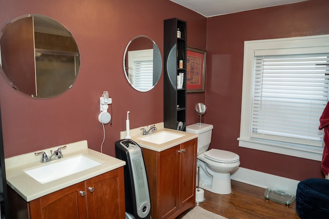 bathroom with hardwood / wood-style floors, vanity, and toilet