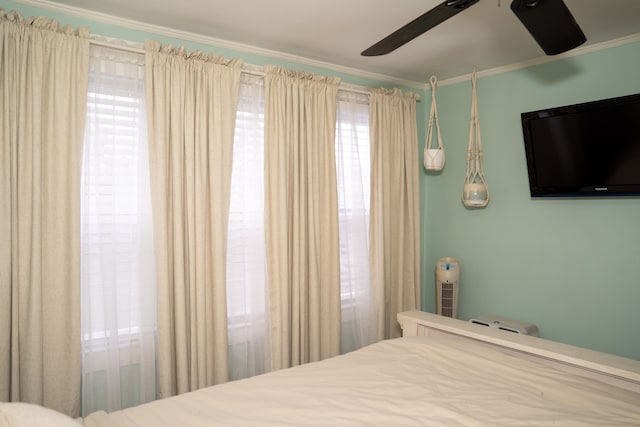 bedroom featuring crown molding and ceiling fan