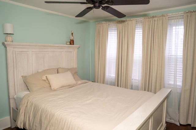 bedroom with ceiling fan and ornamental molding