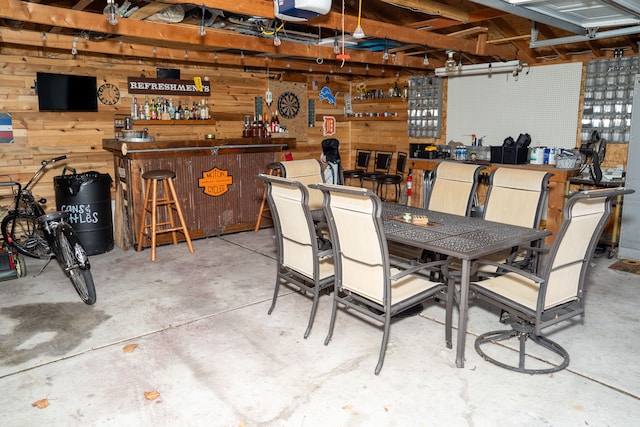 exterior space with a workshop area, wooden walls, and concrete floors