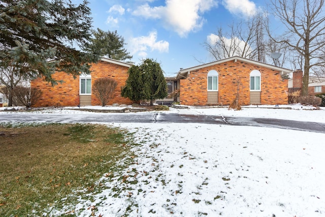 view of snow covered back of property