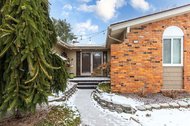 view of snow covered property entrance