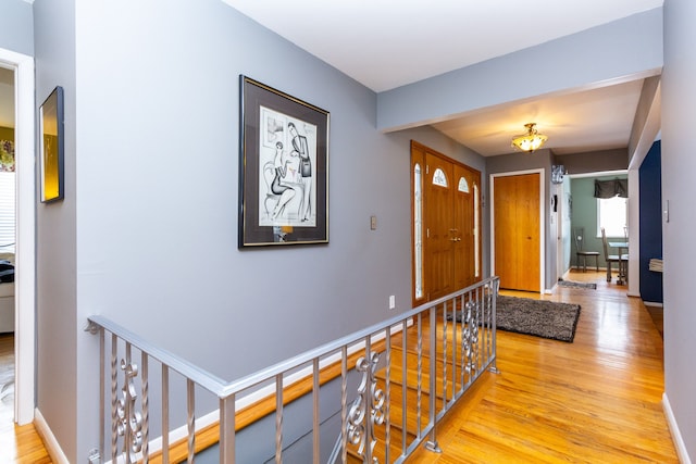 corridor with light hardwood / wood-style floors