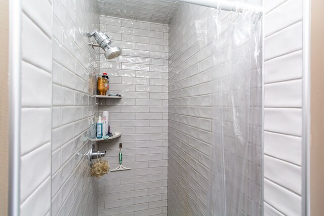 bathroom with a tile shower