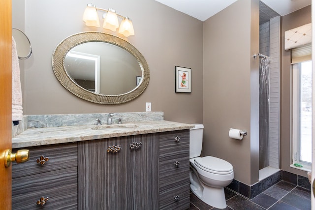 bathroom with tile patterned floors, vanity, curtained shower, and toilet