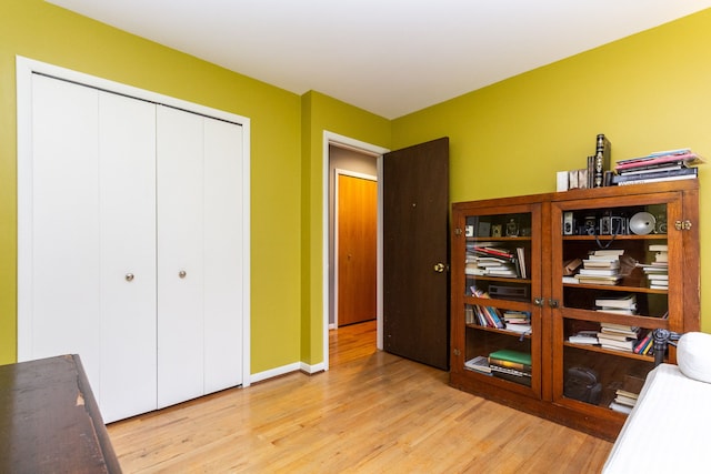 bedroom with a closet and light hardwood / wood-style floors