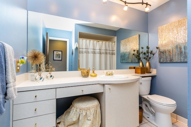 bathroom with tile patterned floors, vanity, toilet, and walk in shower