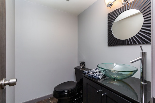 bathroom featuring tile patterned flooring, vanity, and toilet