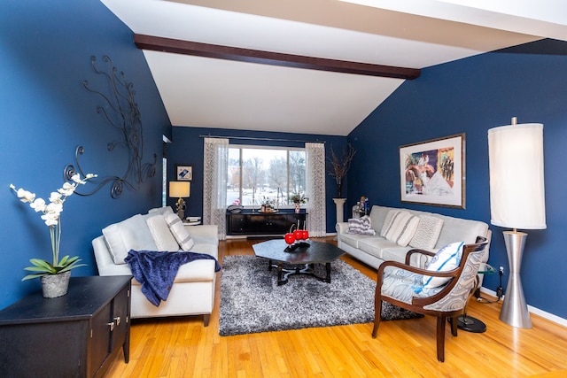 living room with light hardwood / wood-style flooring and lofted ceiling with beams