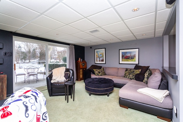 living room with light carpet and a drop ceiling