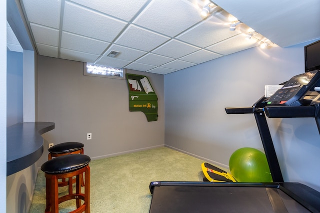 workout room with carpet flooring and a drop ceiling