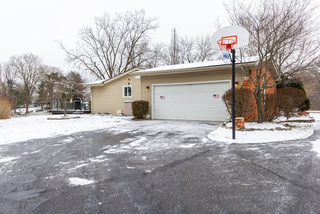 view of snowy exterior featuring a trampoline