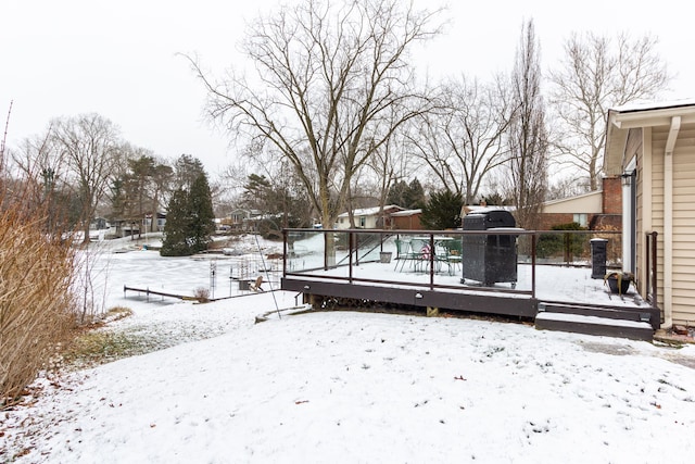 yard covered in snow with a wooden deck