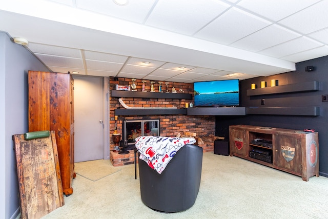 interior space with a fireplace, light carpet, and a drop ceiling