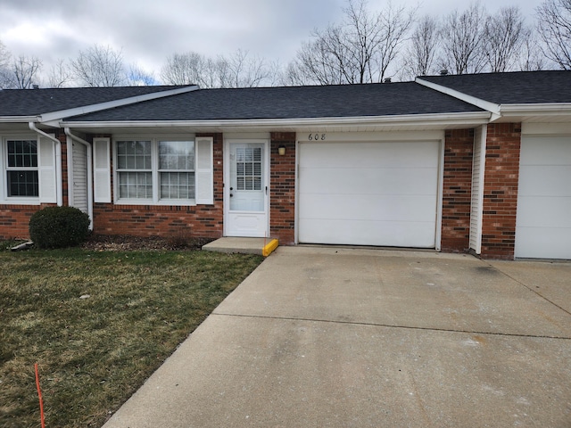 single story home with a front yard and a garage