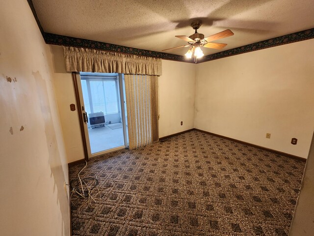 carpeted spare room with a textured ceiling and ceiling fan