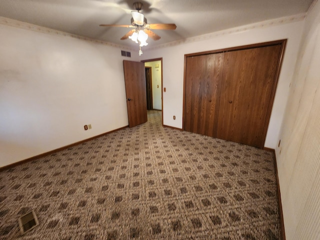unfurnished bedroom featuring carpet floors and ceiling fan