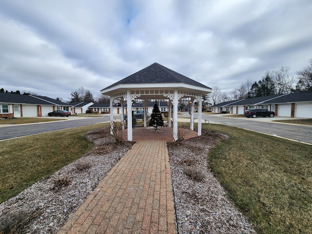 surrounding community with a gazebo and a lawn