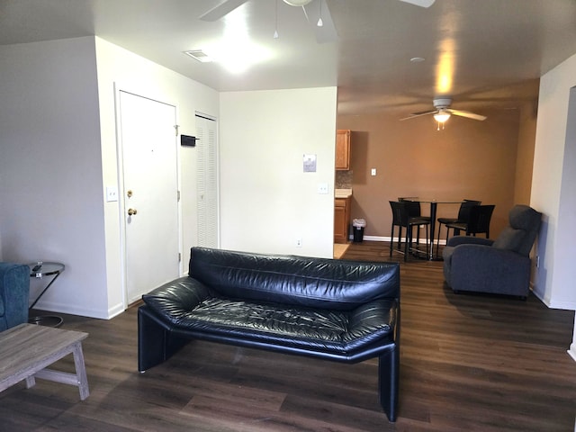 living room with ceiling fan and dark hardwood / wood-style floors