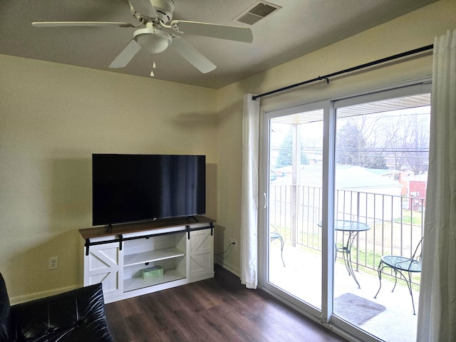 unfurnished living room with ceiling fan and dark hardwood / wood-style flooring