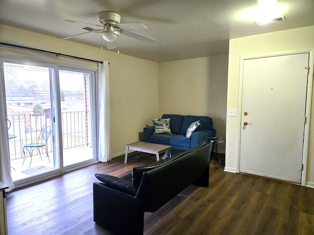 living room with ceiling fan and dark hardwood / wood-style flooring