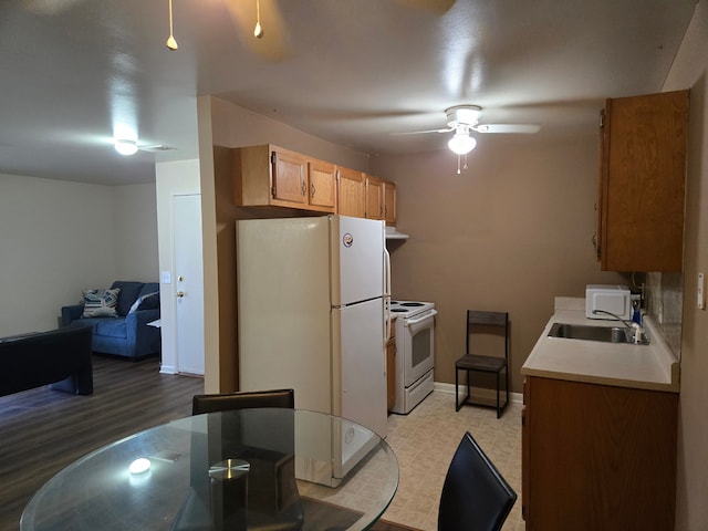 kitchen with ventilation hood, ceiling fan, white appliances, and sink